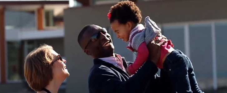 Smiling family playing outside