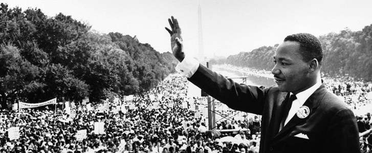 Martin Luther King, Jr. waving at a crowd