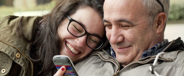 Dad and teen daughter laughing
