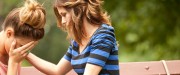 young woman comforts friend