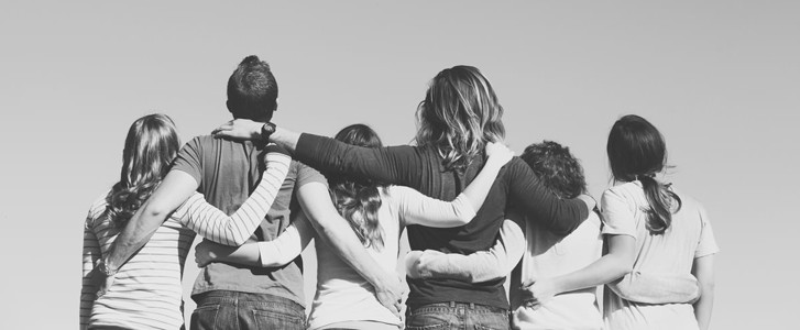 Teens with arms around each other's shoulders