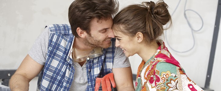 Happy couple with floor plan