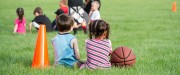 Two children watching a sports practice