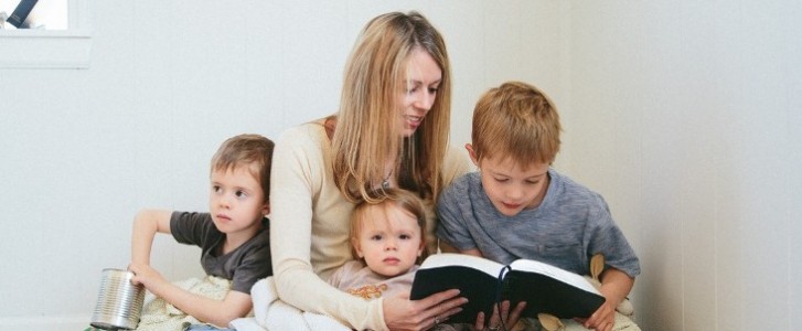 Mom reads the Bible with her kids