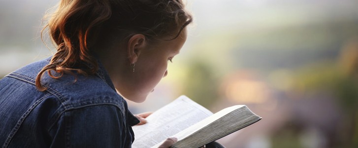 Young girl reading the Bible