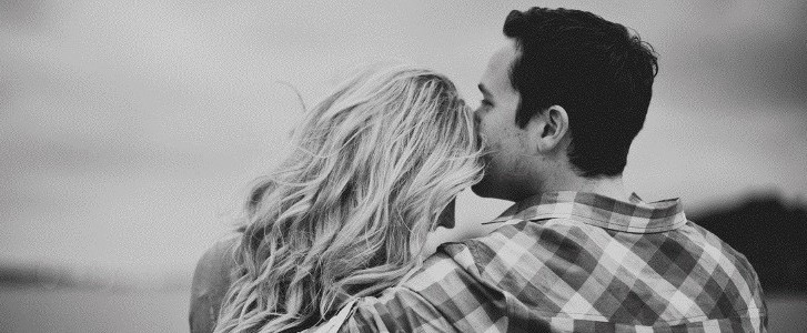 Husband kissing wife's forehead