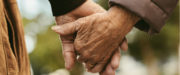 Elderly couple holding hands