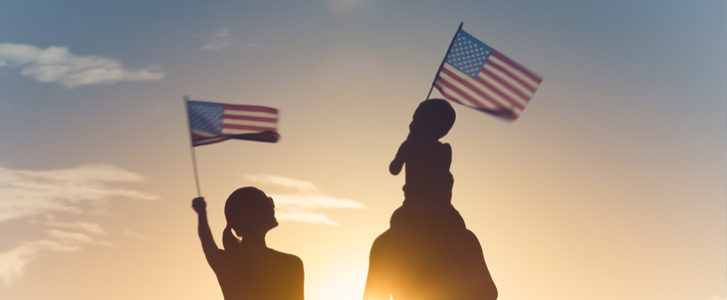A family waving the American flag