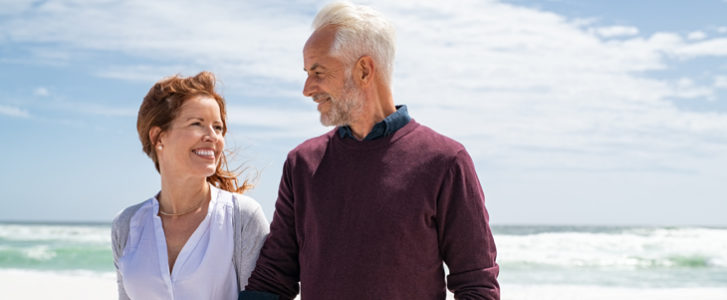 Husband and wife walking on the beach