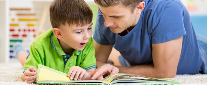 Father and son reading a book