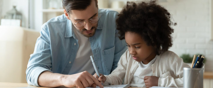 Father helping his daughter with homework