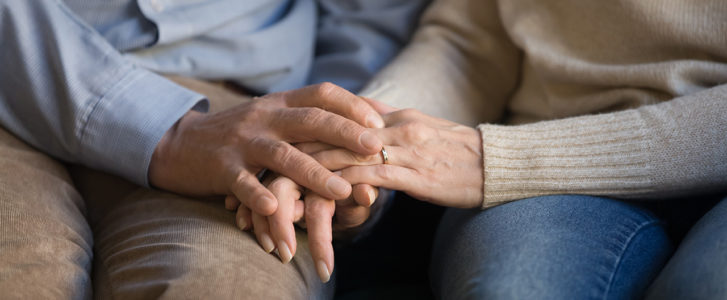 Married couple holding hands
